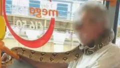 الرجل استخدم الثعبان بدلا من كمامة الوجه