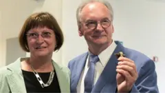 Saxony-Anhalt State Premier Reiner Haseloff of the Christian Democratic party (CDU), and his wife Gabriele, wait for the first election polls to be published for the federal state election of Saxony-Anhalt, in Magdeburg, Germany, June 6, 2021