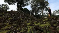 A man sweeps the Gunung Padang site in West Java, Indonesia