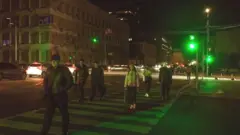 People cross a zebra crossing during an electrical blackout in Kyiv on 31 October