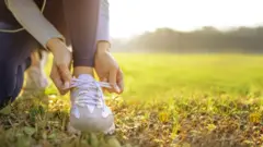 Runner tying her shoes