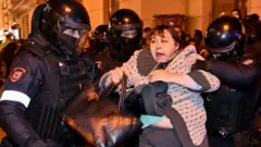 Moscow police detaining woman at anti-mobilisation protest