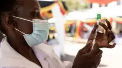 Umuganga urimo gushyira urukingo mu rushinge
