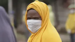 ጭምብል ያጠለቀች ሴት