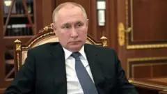 Russian President Vladimir Putin listens to Governor of the Novgorod Region Andrei Nikitin during a meeting at the Kremlin in Moscow, Russia March 22, 2022