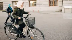 woman cycling on street