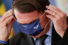 Bolsonaro se atrapalha ao vestir máscara hospitalar