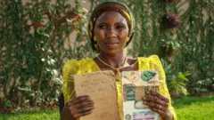 Woman holding up exercise books