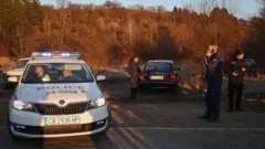 Police work near the site after at least 18 people were found dead in Bulgaria in an abandoned truck near the capital Sofia