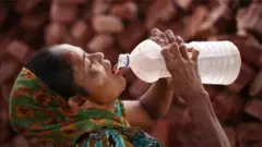 Woman wey dey drink cold water