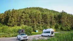 People camping in car and van