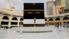 Muslim walk near the Kaaba at the Grand mosque during the Haj, following the outbreak of the coronavirus disease (COVID-19), in Mecca, Saudi Arabia July 26, 2020. Picture taken July 26, 2020