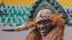 A man in traditional dress parades in the September 24 Stadium prior the ceremony celebrating Independence Day in Bissau on November 16, 2021. - Independence Day 2021 was postponed by two months by decision of President Umaro Sissoco Embalo due to covid-19 and bad weather.