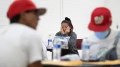 A migrant in Washington DC rubs her eyes after a long journey