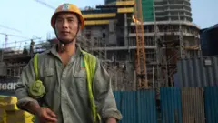 A Chinese construction worker outside a shopping complex building site in Colombo