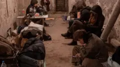 Kyiv residents take shelter in the basement of an apartment building (27 February 2022)
