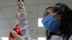 Trabajadora en un laboratorio en Egipto hace una prueba con remdesivir