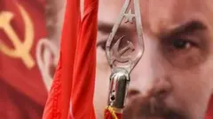 A picture of Vladimir Lenin behind a standard showing the communist symbol