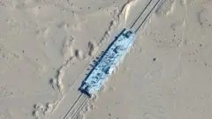 A satellite image shows a mock-up US military ship in the desert in Xinjiang, north-western China