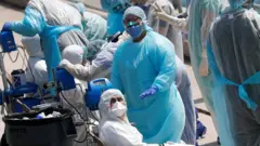 First responders evacuate sick crew members with flu-like symptoms from two cruise ships in Miami