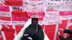 BTS fans leaving notes on red and pink paper strips