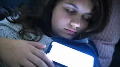 Mobile phones beside bed