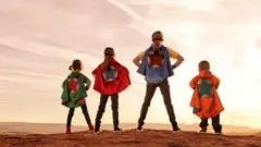 Siblings dressed as superheroes