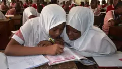 Female students wey wear hijab.
