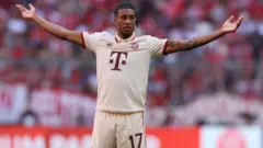 Michael Olise stand and stretch im arms 