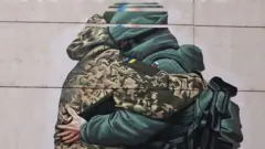 Mural showing Ukrainian and Russian soldier hugging