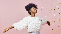 Happy woman in a light pink background