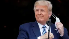 Trump removes mask