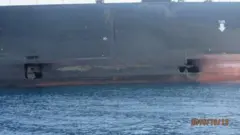 Photo of two holes in an Iranian tanker