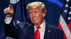 Former U.S. President and Republican candidate Donald Trump gestures at a Republican fundraising dinner in South Carolina in 6 August