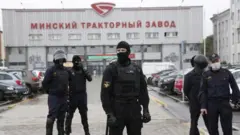 Belarus riot policemen (OMON) stand in front of the Minsk Tractor Plant to prevent any rally or attempt to organize a strike in Minsk, Belarus, 19 August 2020.