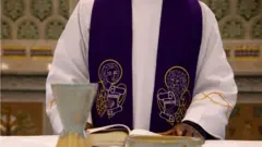 Priest in front of communion