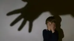 stock picture of child with hands over face