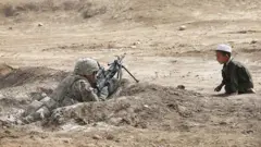 2014 - ایک افغان بچہ قندھار میں امریکی فوجی کو غور سے دیکھتے ہوئے