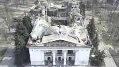 A view shows the building of a destroyed theatre in Mariupol