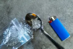 필로폰(Crystal meth), 파란색 라이터, 그리고 그을린 숟가락이 콘크리트 바닥에 놓여 있어 불법 마약 사용과 중독이라는 주제를 상징적으로 보여줌