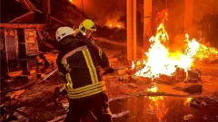 Emergency services work to control fire at business centre and warehouse in Odesa