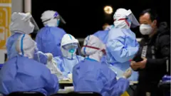 Medical staff in Hazmat suits