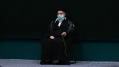 د﻿ر تصاویری که از مراسم امروز توسط سایت رسمی آقای خامنه ای منتشر شده، رهبر جمهوری اسلامی ایران مطابق رویه ای که پس از شیوع ویروس کروناه داشته ماسک به صورت دارد