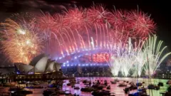 Fireworks explode over the harbour and the Sydney Harbour Bridge landmark during New Year celebrations in Sydney, Australia