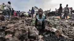 Child sits on the rubble