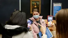 tourists wearing protective face masks