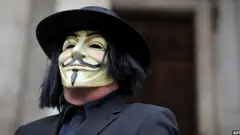 A masked protestor stands on the steps of St Paul's Cathedral in London