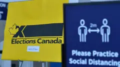 COVID-19 and Elections Canada related signs seen inside Edmonton Expo Center hall