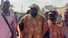 Some pipo dress up as Baba Suwe for di burial