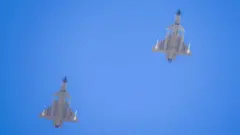 Two J-16 air fighters fly over a training base of PLA's naval aviation force in Ningbo in east China's Zhejiang province